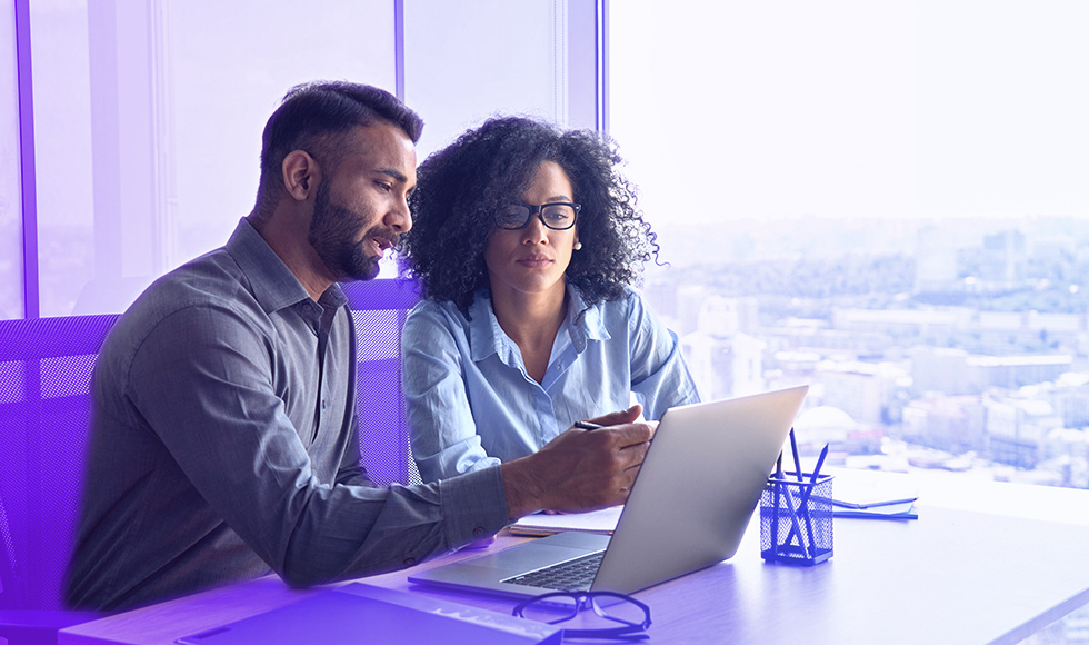 two colleagues working together on a laptop